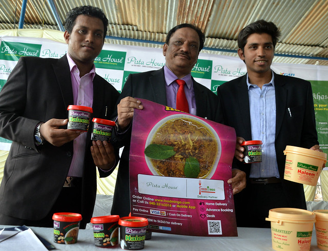 M.A.Majeed, MD of Pista, with his sons showcasing Pista House Haleem containers and streamers during a press conference in Hyderabad on Friday afternoon.