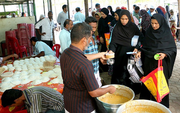 Bystanders are given Iftaar meals at the hall set up in front of the C H Muhammed Koya Memorial Charitable Centre at Kozhikode Government Medical College.