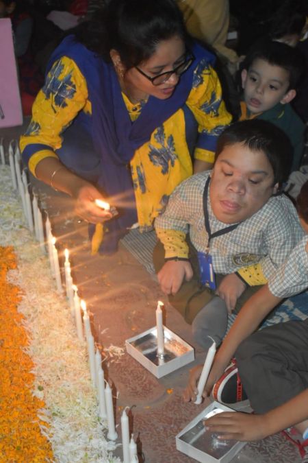 Special children with congenital disabilities being helped to lit candles on the eve of 1984 Bhopal Gas Tragedy's 34th anniversary.