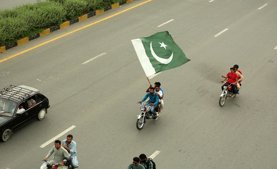ISLAMABAD, Aug. 14, 2019 (Xinhua) -- A Pakistani man on a motorcycle holds a national flag during the Independence Day celebrations in Islamabad, Pakistan, on Aug. 14, 2019. Pakistan got independence from the British colonial rule on Aug. 14, 1947. (Xinhua/Ahmad Kamal/IANS)